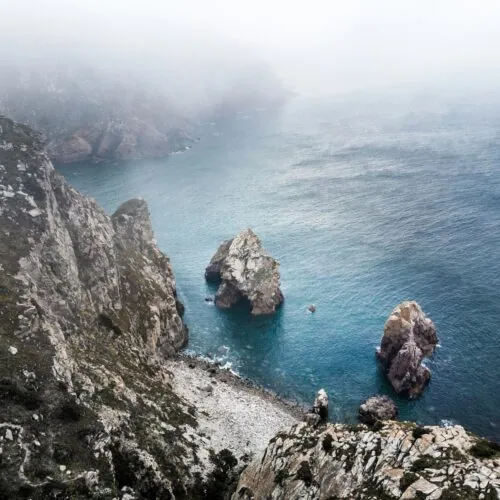 Rocky coastal environment with sea cliffs and marine waters illustrating airborne chloride exposure